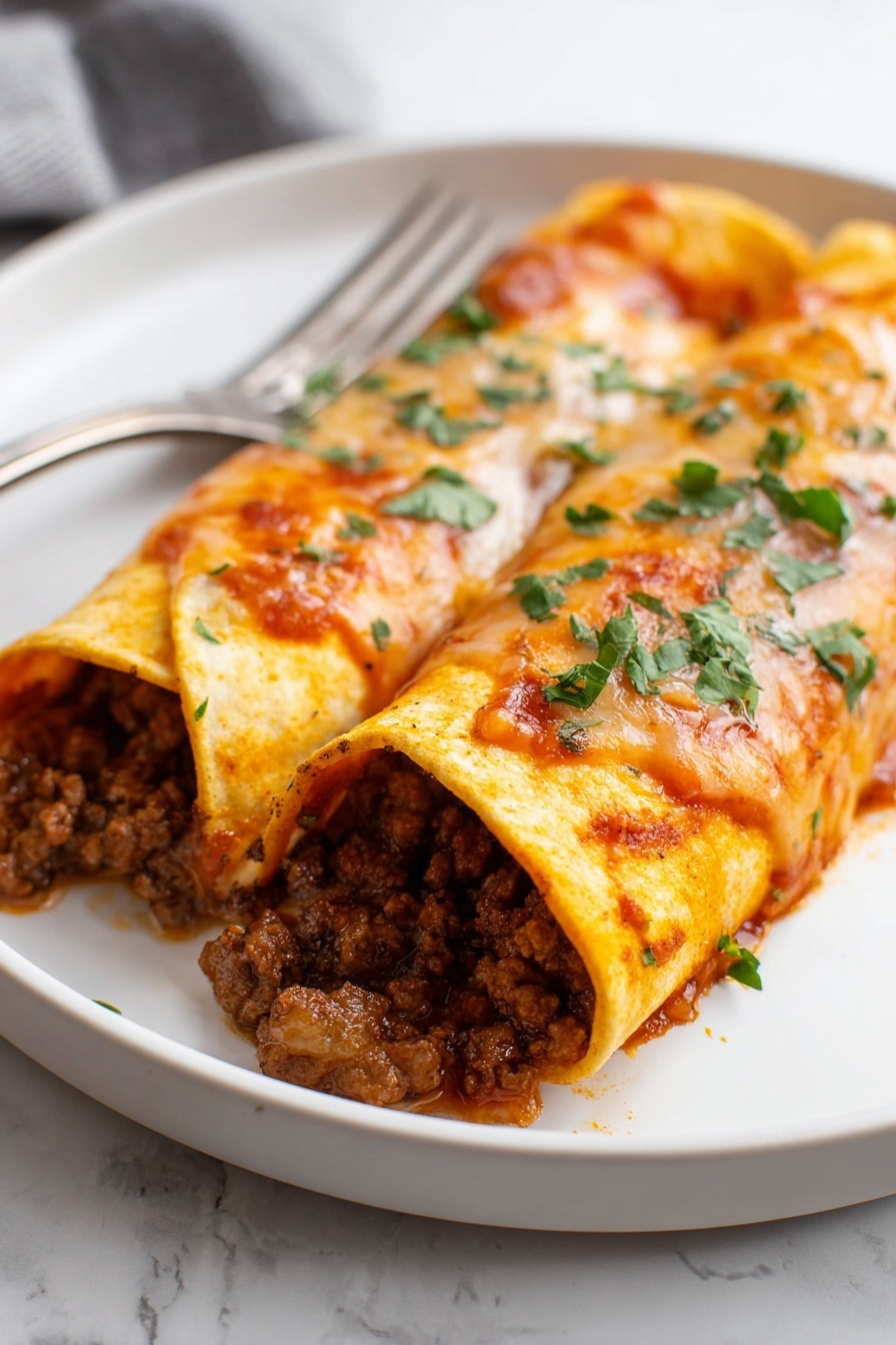 Beef Enchiladas - The image shows a white baking dish filled with four rolled enchiladas placed side by side. Each enchilada is covered with a thick, bright orange-red sauce and melted cheese that is slightly golden and smooth in texture. Inside the enchiladas, you can see a rich, dark brown meat filling that looks moist and chunky. Fresh, chopped green cilantro is sprinkled evenly on top, adding a pop of color. The sauce inside the dish pools slightly around the bottom edges, giving a saucy and inviting look. The dish is sitting on a white marbled surface. Photo taken with an iphone --ar 2:3 --v 7
