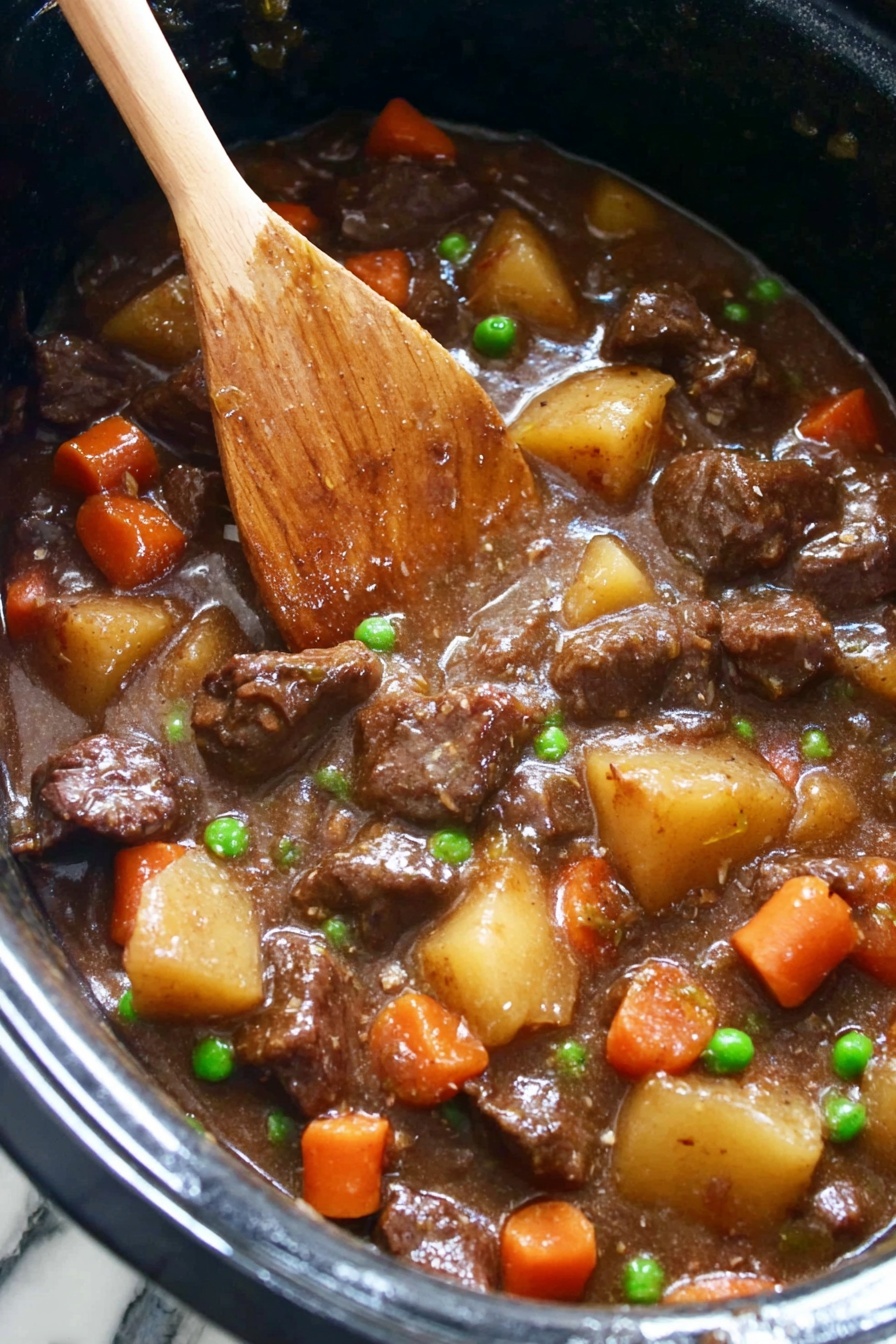 The image shows a thick beef stew in a black pot. The stew has chunks of dark brown beef mixed with small round orange carrot slices, light tan potato pieces, and small bright green peas. The stew sauce is smooth and brown, coating all the ingredients. A wooden spoon stands inside the pot, partially submerged in the rich stew with some sauce on it. The background is a white marbled texture. photo taken with an iphone --ar 2:3 --v 7