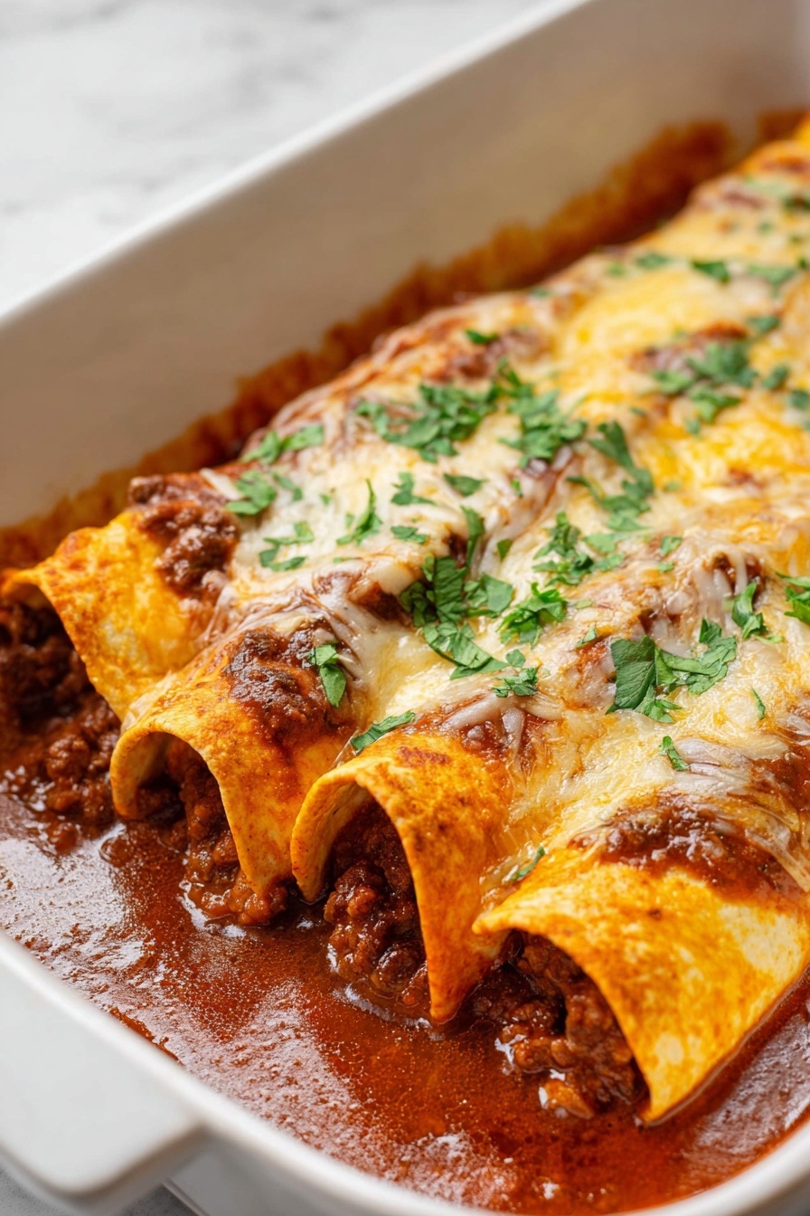 Beef Enchiladas - Two rolled enchiladas lie side by side on a white plate, each filled with a rich, dark brown meat mixture with visible small pieces of cooked onions and peppers spilling out at the front. The top of the enchiladas is covered with a layer of melted, golden cheese with some orange-red enchilada sauce peeking through. Fresh, chopped green cilantro is sprinkled generously over the cheese, adding a fresh touch of color. A silver fork rests on the plate behind the enchiladas, all set on a white marbled surface. Photo taken with an iphone --ar 2:3 --v 7