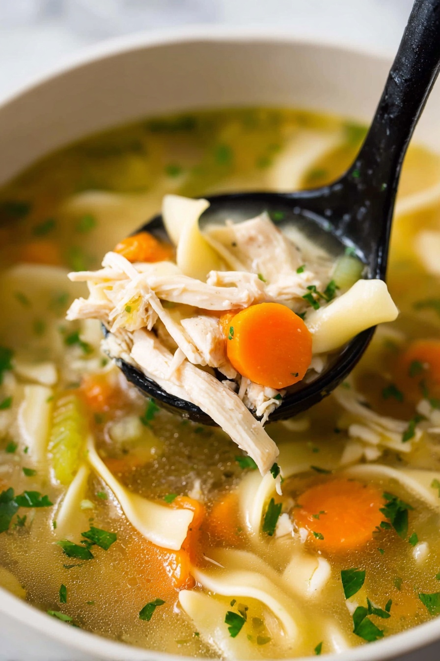A white pot filled with chicken noodle soup, showing three layers: at the bottom, a light golden broth with small green herb specks; the middle layer has thick, white noodles and bright orange carrot slices; on top, shredded white chicken pieces mixed with celery chunks and sprinkled with fresh green herbs. A woman's hand holds a black spoon lifting noodles, chicken, and carrots from the pot. The pot sits on a white marbled surface with some green herbs in the top right corner and a gray striped cloth below. Photo taken with an iphone --ar 2:3 --v 7