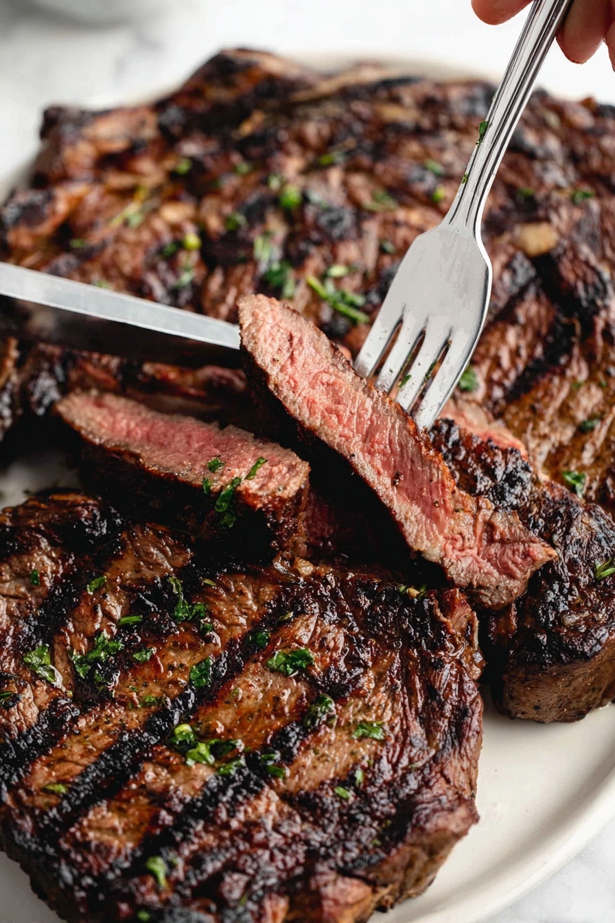 A close-up view of a large grilled steak lying flat on a white plate with a white marbled surface underneath. The steak has dark brown char marks and a slightly crispy texture on the outside, with faint green herb sprinkles scattered on top. Several slices are arranged around the main steak, showing a medium-rare, pinkish inside with juicy textures. A shiny silver fork held by a woman's hand is lifting one thick slice, highlighting the tender, pink center and the charred outer edges. photo taken with an iphone --ar 2:3 --v 7