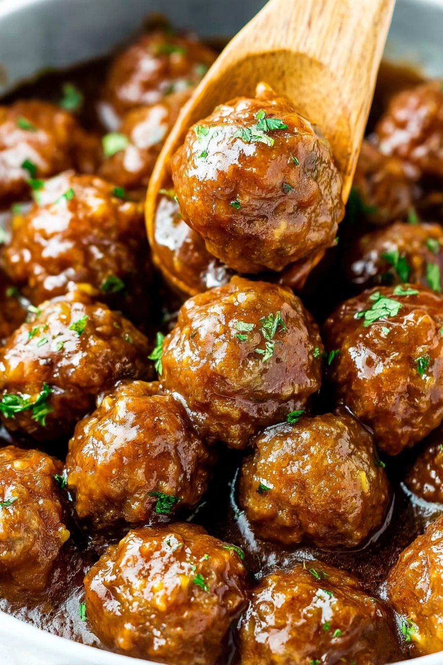 This image shows a close-up of many round meatballs covered in a shiny brown sauce. The meatballs look soft and moist with a slightly textured surface. They are sprinkled with small pieces of fresh green herbs scattered evenly over the top. A wooden spoon is partially visible, gently lifting some of the meatballs from the dish. The meatballs are arranged closely together in a white bowl. The background is a white marbled texture, adding a clean and bright look to the image. Photo taken with an iphone --ar 2:3 --v 7
