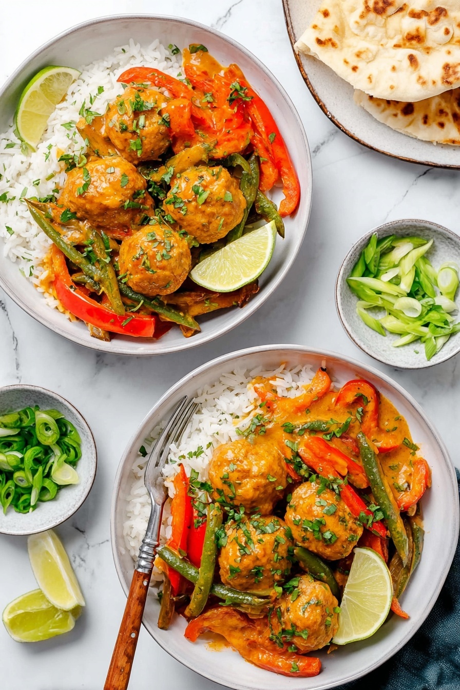 A black skillet filled with about sixteen round light brown meatballs covered in a creamy orange sauce, mixed with sliced yellow and red bell peppers and whole green asparagus pieces. The dish is topped with scattered chopped green onions and fresh green herbs. A wooden spoon is partially inside the skillet on the left side. The skillet is placed on a white marbled surface with a beige bowl of lemon wedges in the upper left corner and a small bowl of green sliced onions in the lower right corner. photo taken with an iphone --ar 2:3 --v 7