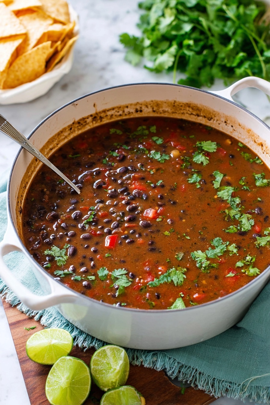 A close-up view of a white pot filled with a dark brown, thick, and chunky soup. The soup has visible layers of black beans, red bell pepper pieces, and bits of meat mixed throughout. Bright green cilantro leaves float on the surface, adding a fresh touch. A silver ladle scoops up a portion, showing the mixture’s dense texture with more beans, red peppers, and cilantro clearly seen. The pot rests on a white marbled surface with a slight splash of soup on the rim. Photo taken with an iphone --ar 2:3 --v 7