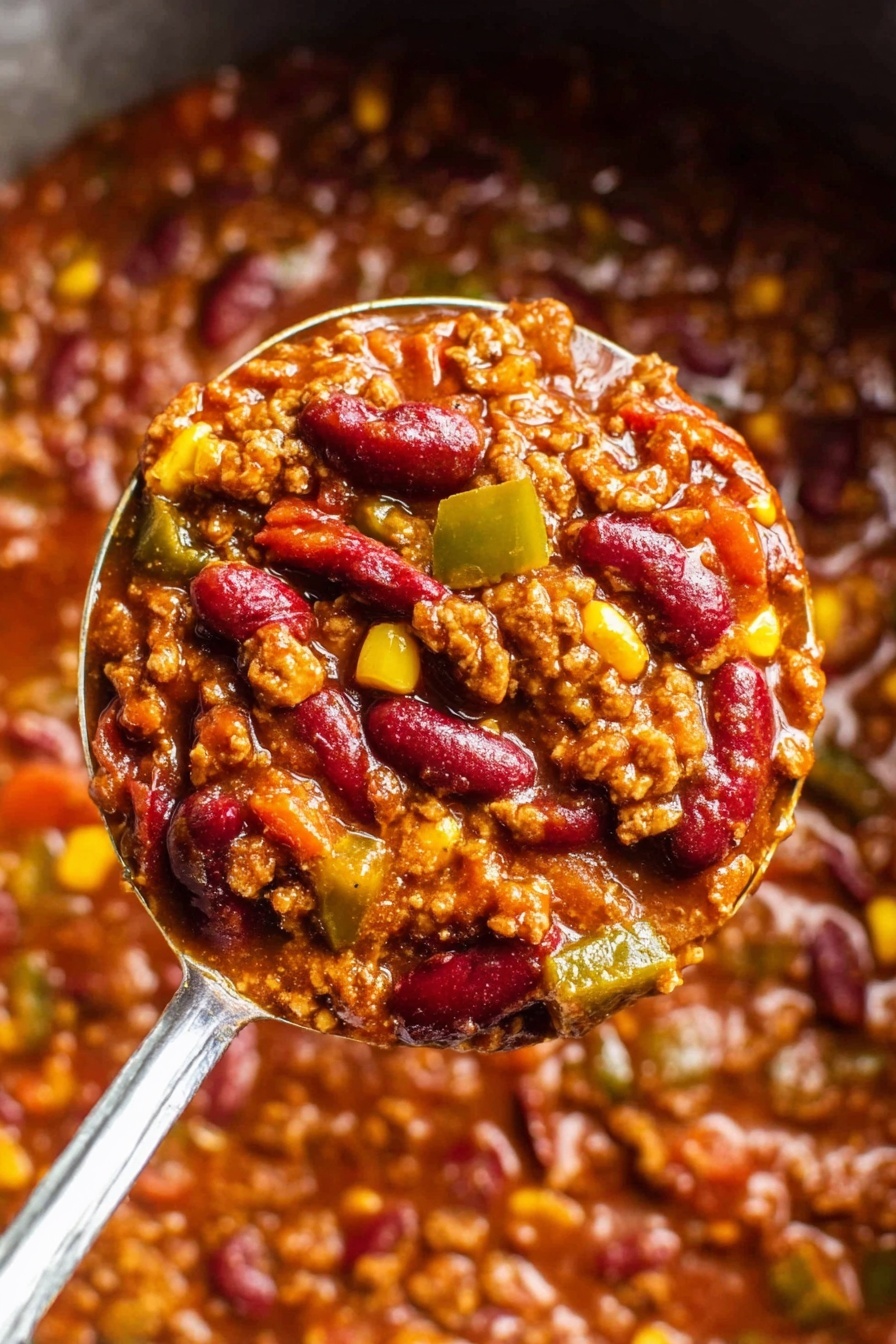 The image shows a close-up of a thick, rich chili mixture held by a metal ladle. The chili has several layers: red kidney beans that are glossy and plump, browned ground meat with a crumbly texture, small pieces of yellow corn, and diced green bell peppers. These ingredients are all combined in a thick reddish-brown sauce that looks smooth and slightly oily with visible spices and herbs. The ladle is shiny silver, with the chili filling it almost to the edge, and the rest of the chili fills the background with the same vibrant colors and textures. The photo is taken with a white marbled textured background. photo taken with an iphone --ar 2:3 --v 7