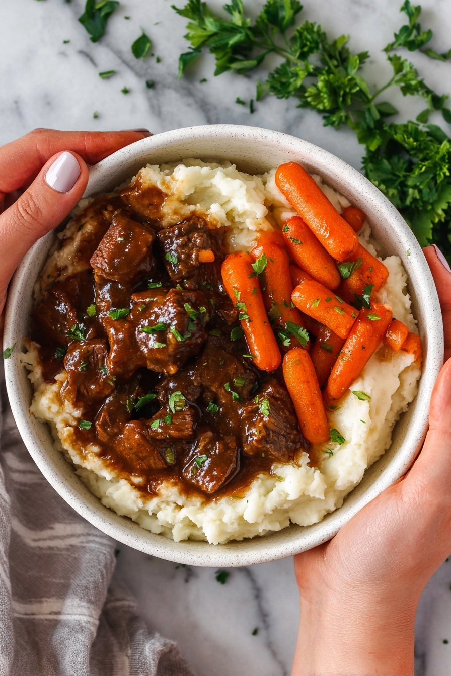 A silver frying pan is shown from above with small pieces of beef cooking inside. The beef chunks have browned edges with a mix of pink and red centers, showing they are partially cooked. The pan has some browned bits and oil residue scattered around the meat. The background is a white marbled surface with soft natural light highlighting the shiny metal pan and the texture of the meat. Steam rises gently from the beef. photo taken with an iphone --ar 2:3 --v 7