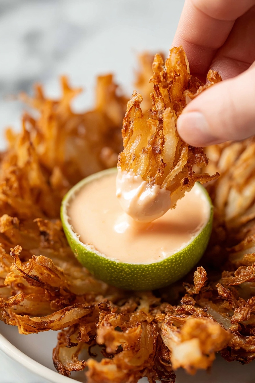 A white onion is arranged like a flower on a wooden board with many layers of thick, curved, white petals that have a shiny texture and greenish veins near their base. The onion petals are spread open in a circular shape standing upright from the center. Next to the onion is a small pile of white onion rings with a pale yellow center, and a gray and white striped cloth is partially visible on the right side. The background shows a smooth white marbled surface with part of a white bowl blurred in the upper left corner. photo taken with an iphone --ar 2:3 --v 7