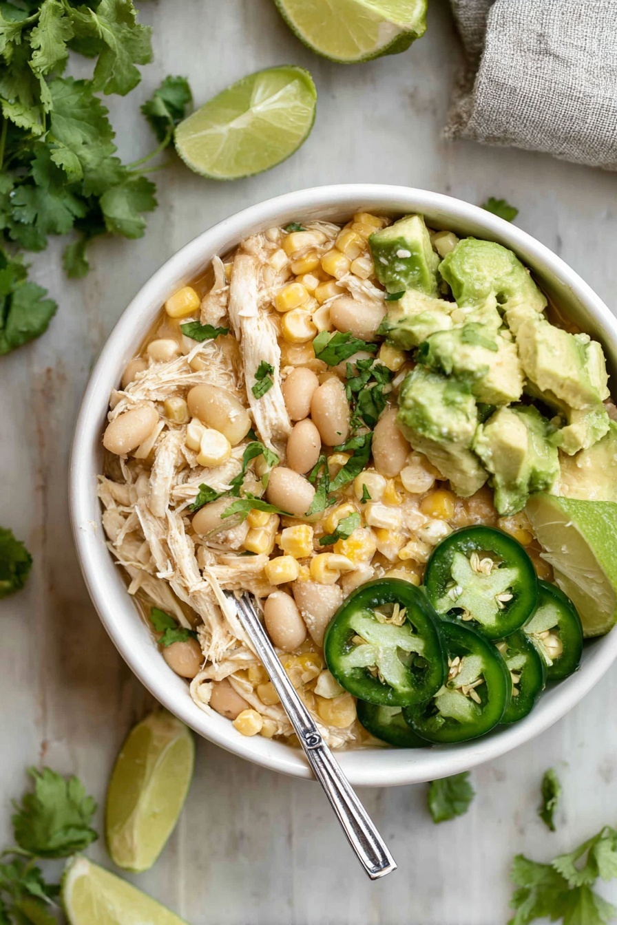 The image shows an open stainless steel pot with several layers of ingredients inside. The top left has bright yellow corn kernels, the top right has light brown beans, and the middle has a greenish sauce or paste. Near the bottom center are light beige powders of different spices and a thick white dollop that looks like sour cream or yogurt, all sitting on a white marbled surface around the pot. Some bits of browned, soft onion pieces are also visible mixed with the spices. photo taken with an iphone --ar 2:3 --v 7