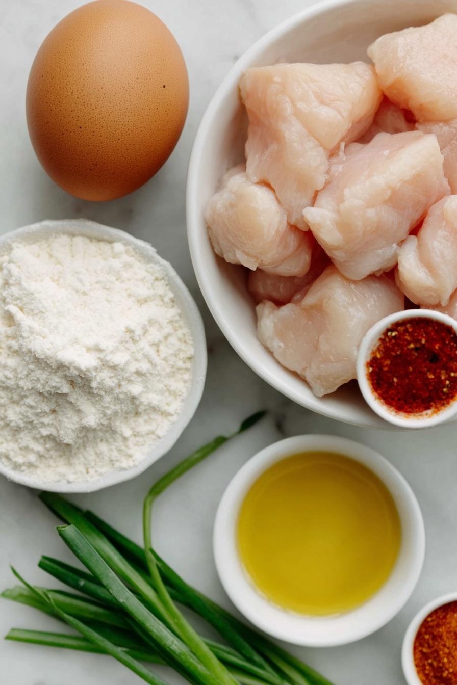 Flat lay of boneless skinless chicken pieces, one large brown egg with uncracked shell, a small pile of pale white cornstarch, a few sprigs of fresh green onions, a small white ceramic bowl with reddish sweet chili sauce, a small white ceramic bowl with golden vegetable oil, a small white ceramic bowl with paprika powder, a small white ceramic bowl with garlic salt, placed on a clean white marble surface, soft natural light, photo taken with an iPhone, professional food photography style, fresh ingredients, white ceramic bowls, no bottles, no duplicates, no utensils, no packaging --ar 2:3 --v 7 --p m7354615311229779997